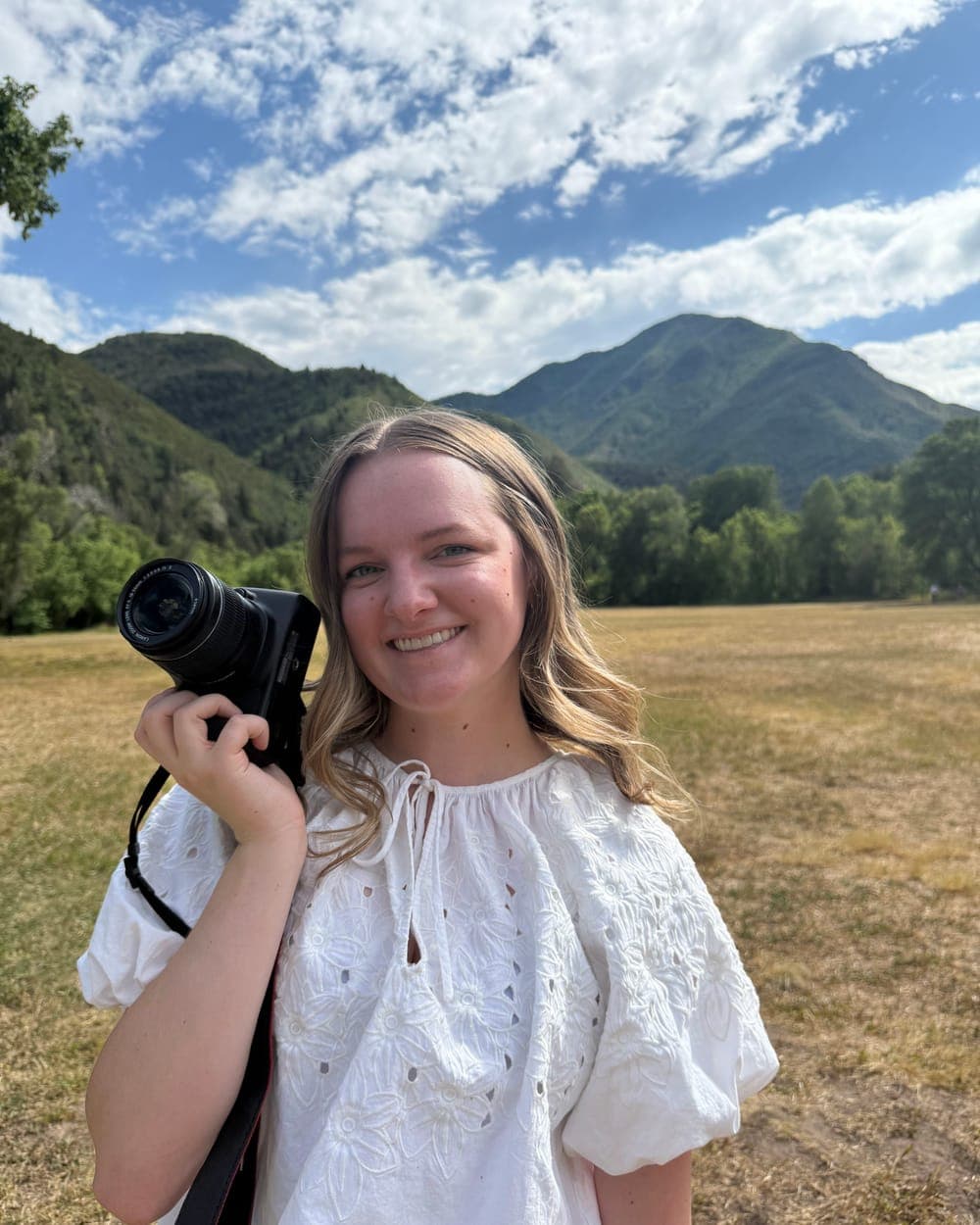Krista with her camera in a golden field